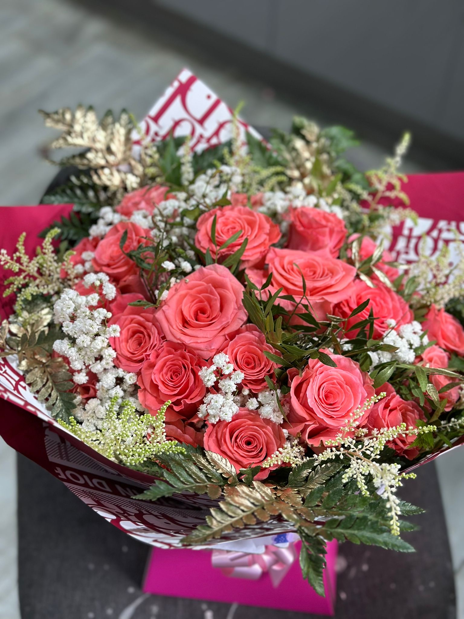 Coral roses with gold accents in patterned wrap