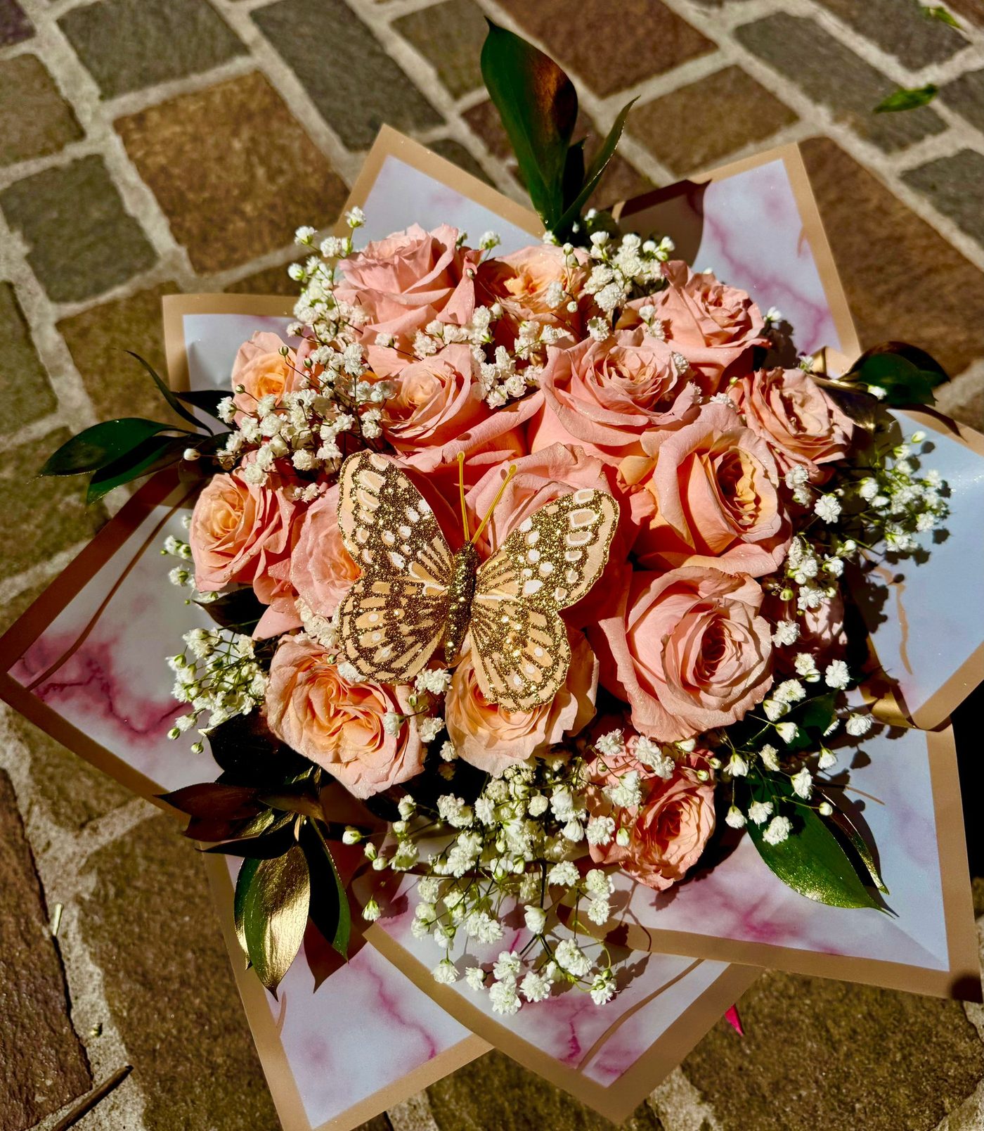 Peach roses with gold butterfly accents