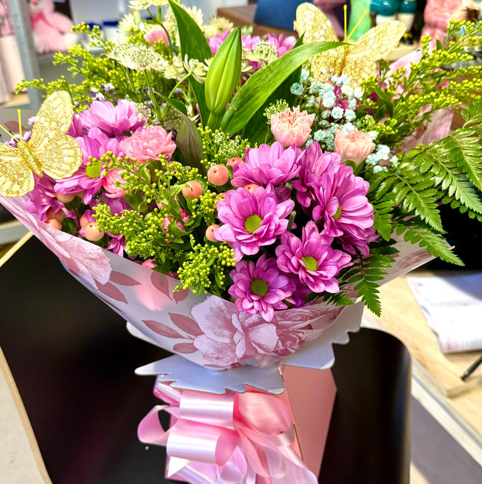 Pink chrysanthemums with gold butterfly