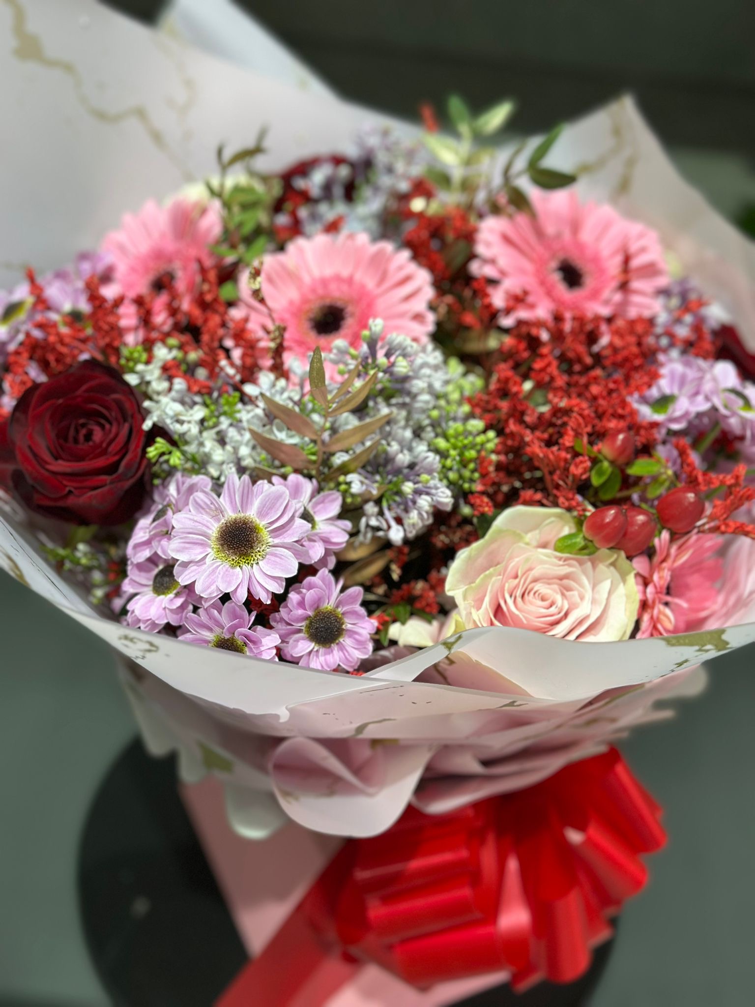 Pink gerbera mixed bouquet on hatbox