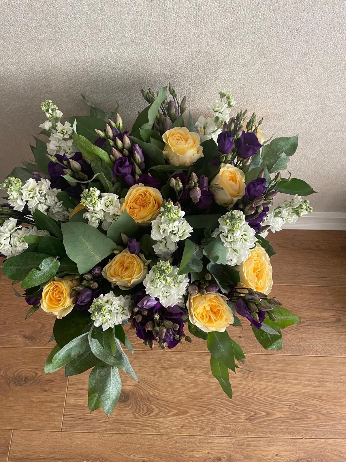 Yellow roses with purple lisianthus and white stocks