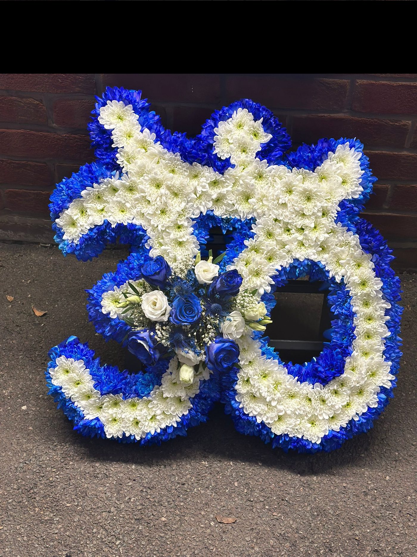 Blue Om symbol funeral tribute