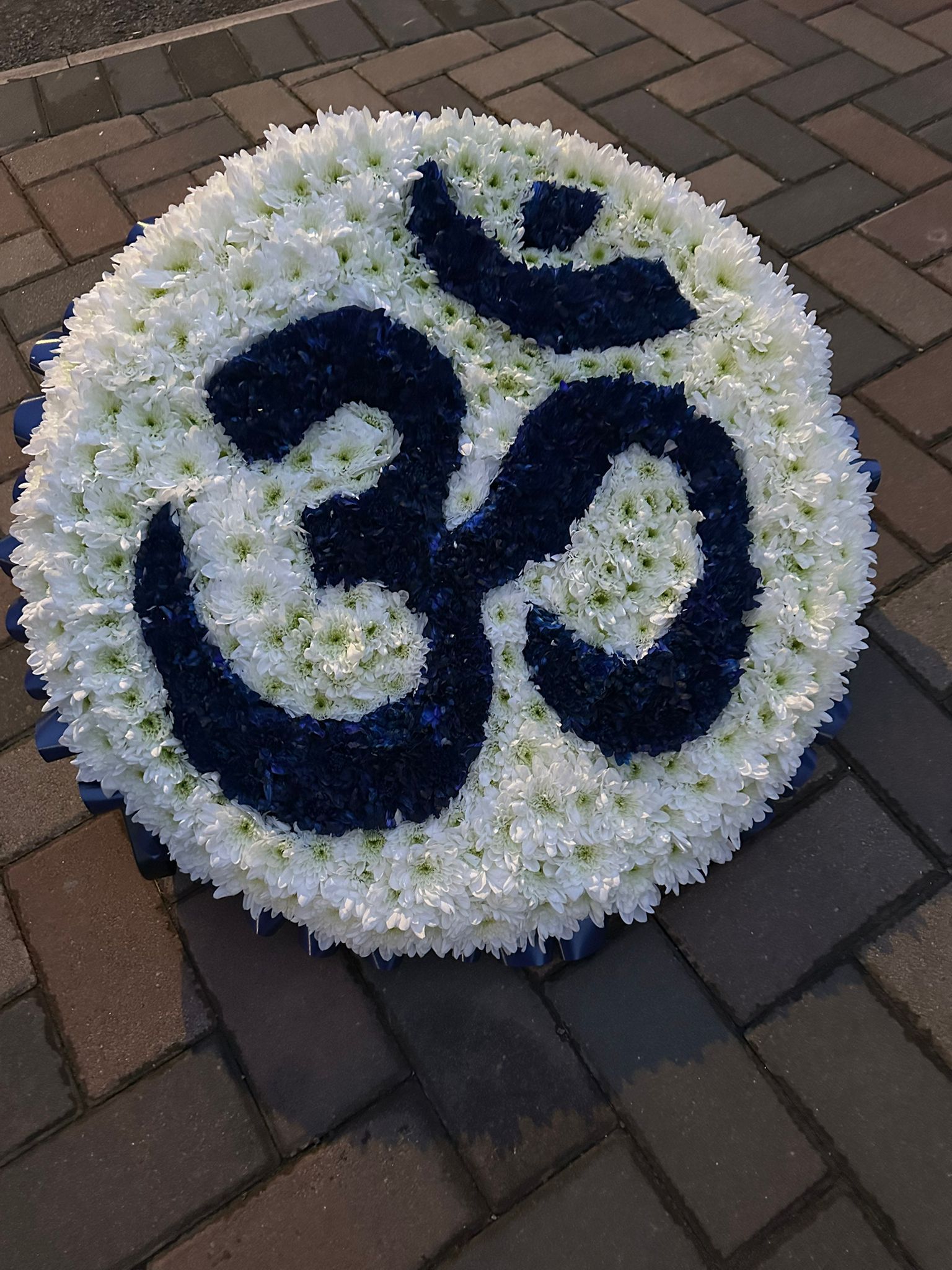 Round Om symbol funeral tribute