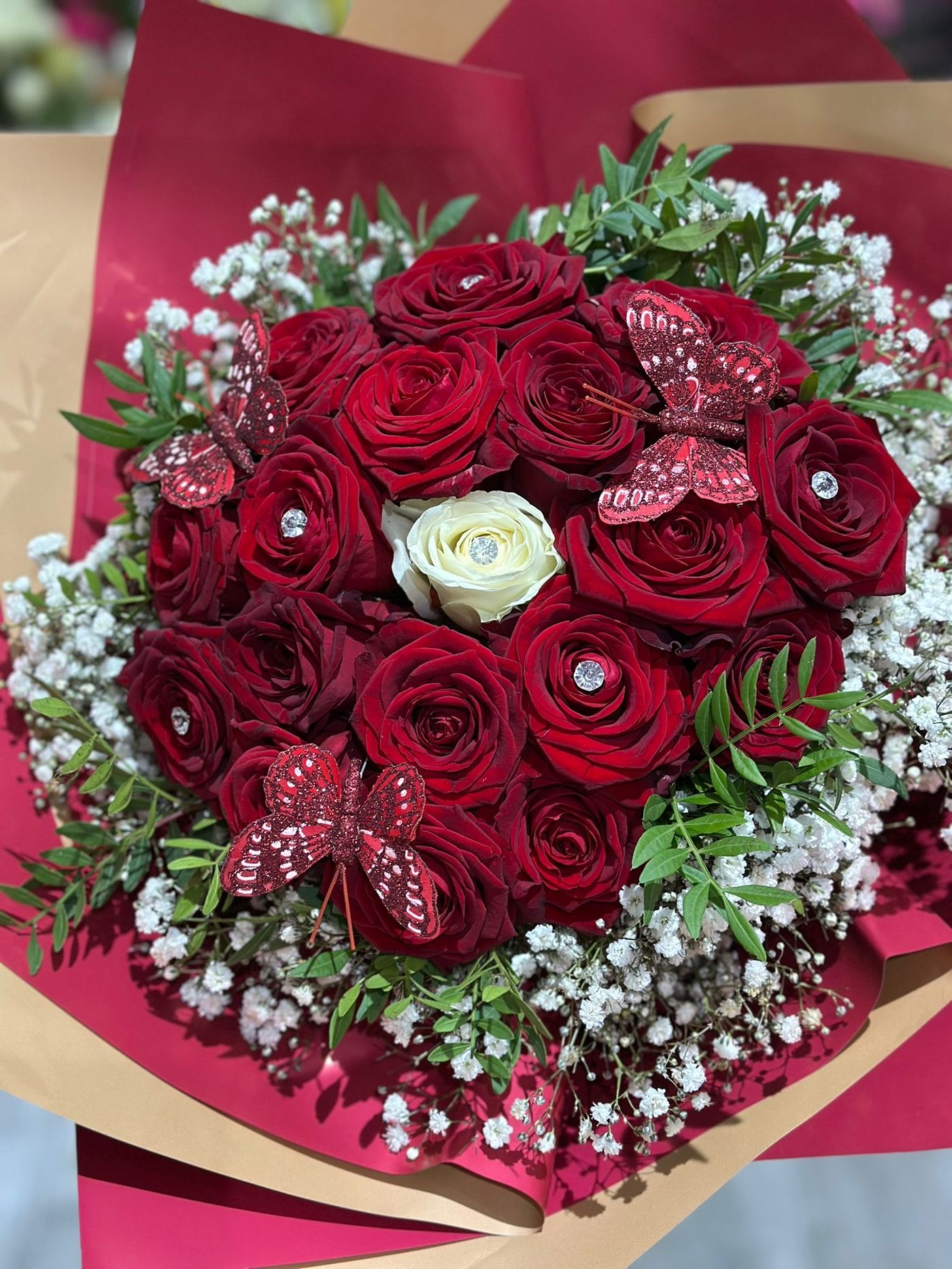 Red roses with burgundy butterfly accents